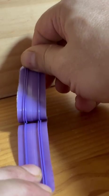 Banda reflectante ECOFIXWEAR siendo retirada de la canaleta con la mano